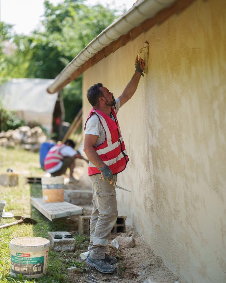 &Eacute;quipe ALP au travail : fa&ccedil;ades et enduits, avec le logo ALP visible sur les v&ecirc;tements.